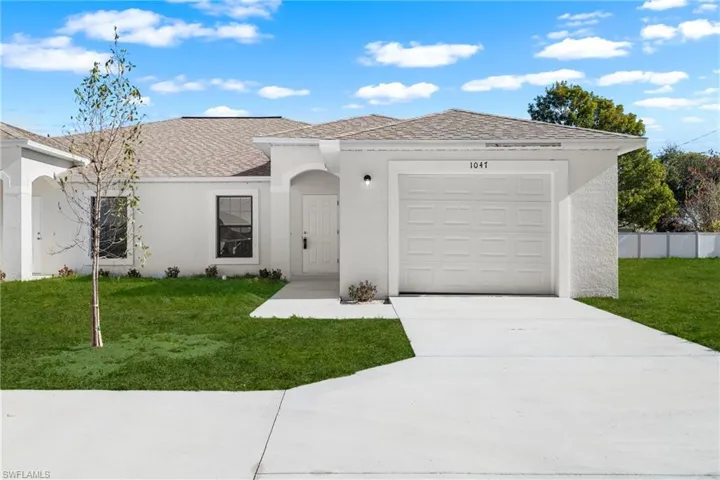 Front exterior featuring a stucco finish, attached garage, and a concrete driveway