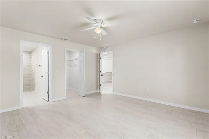 Spacious room featuring wood-finish flooring and neutral wall tones