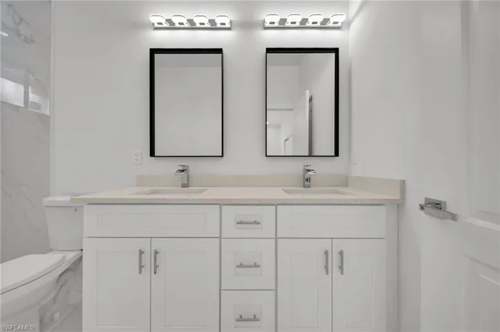 Bathroom with toilet and double vanity