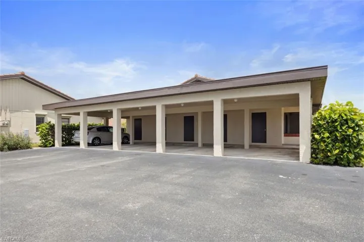 Garage featuring a carport & private large storage closet.