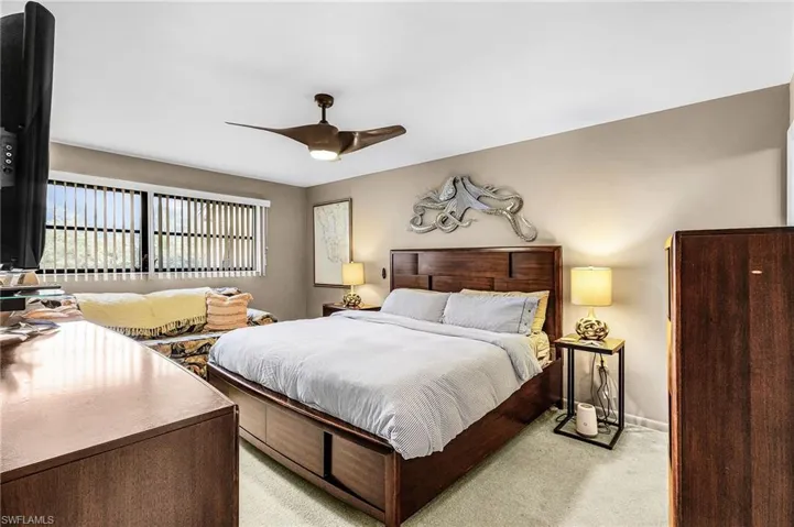 Bedroom featuring light colored carpet and ceiling fan