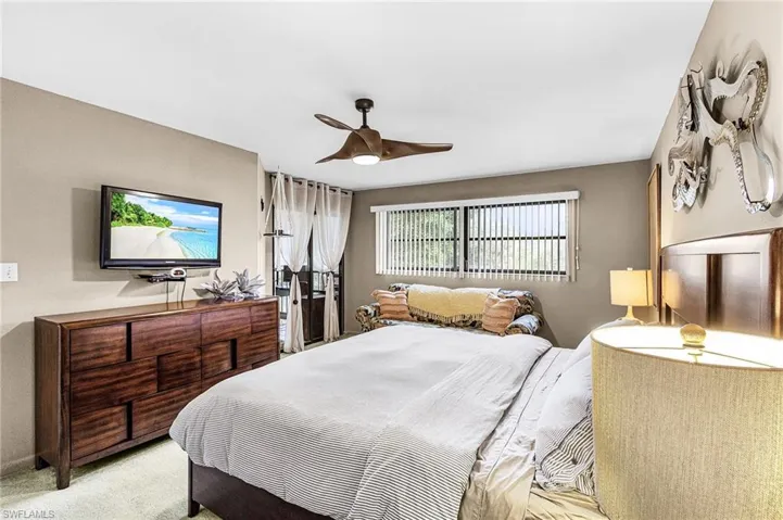 Bedroom with ceiling fan and carpet