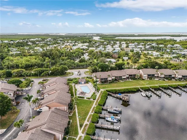 Aerial view of property's location with a large body of water and nearby suburban area