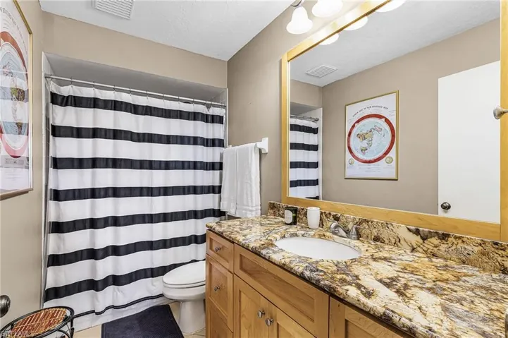 Bathroom featuring vanity and curtained shower