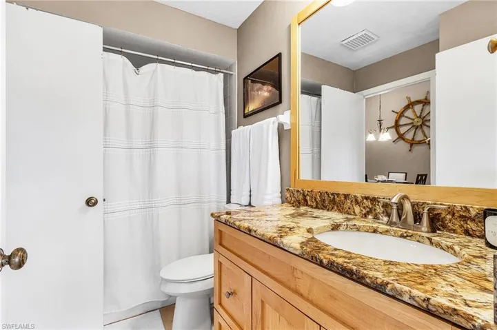 Full bathroom featuring a shower with curtain and vanity
