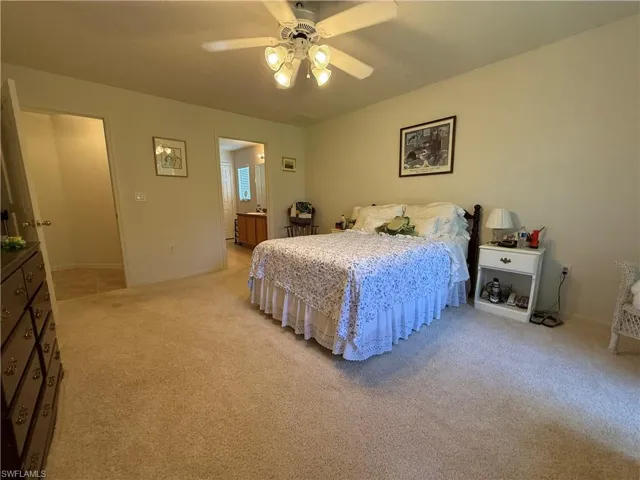 Bedroom with light carpet and ceiling fan