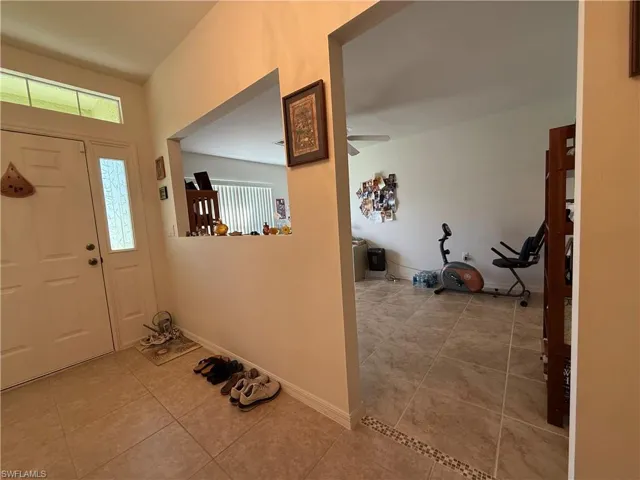 Living area featuring ceiling fan, carpet, and lofted ceiling
