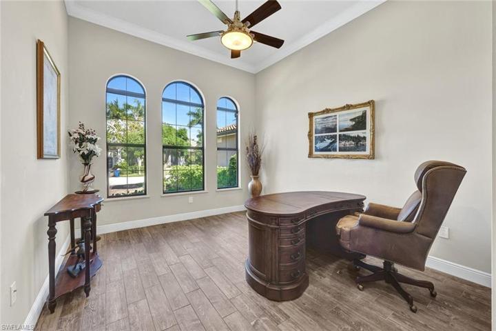 Enjoy your office/den views with beautiful arched window feature, crown molding and ceiling fan!