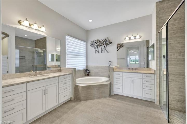 Primary bathroom with separate vanities, soaker tub, and walk-in shower!