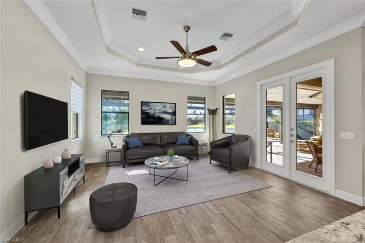 Wood plank tile floors, recessed ceiling with crowne molding finish, and French doors leading to your outdoor oasis!