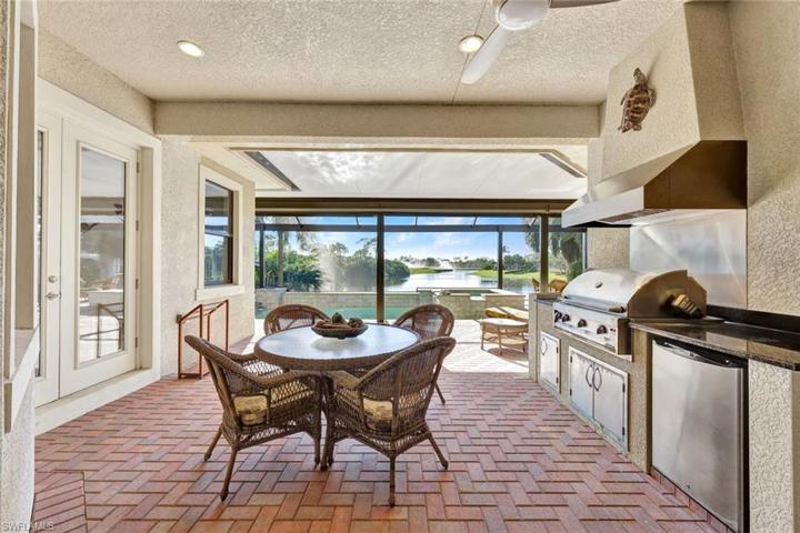 Welcome to your outdoor oasis with built-in summer kitchen and hood, covered seating area and the most beautiful backyard views!