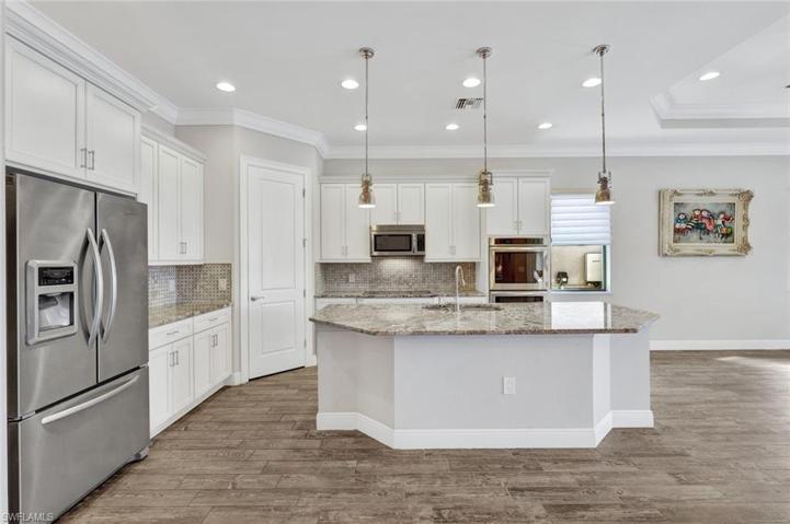 Gorgeous neutral kitchen with French door refrigerator, and walk-in pantry.