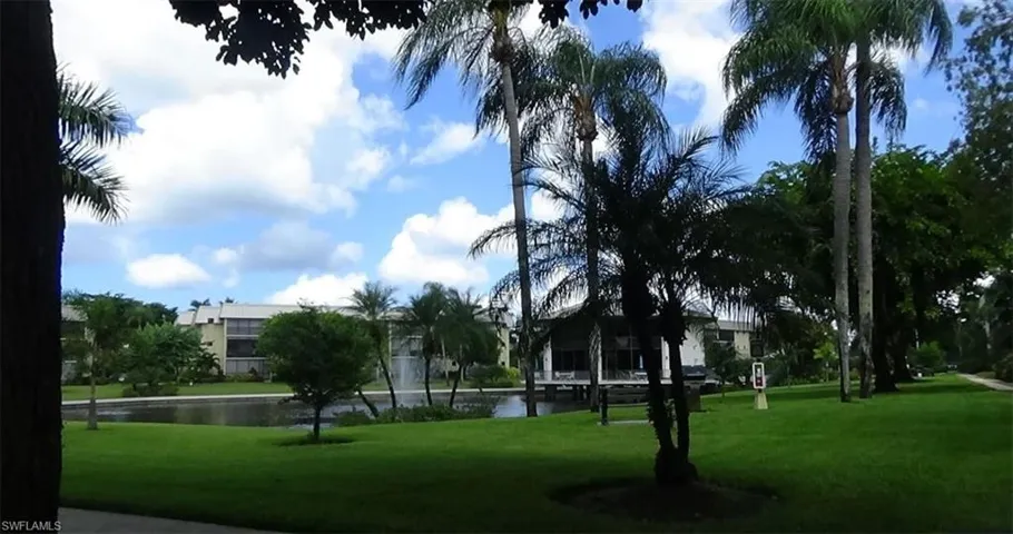 View of home's community with a water view and a yard