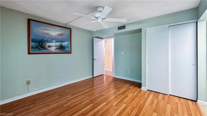 Unfurnished bedroom featuring ceiling fan, a textured ceiling, light hardwood / wood-style flooring, and a closet