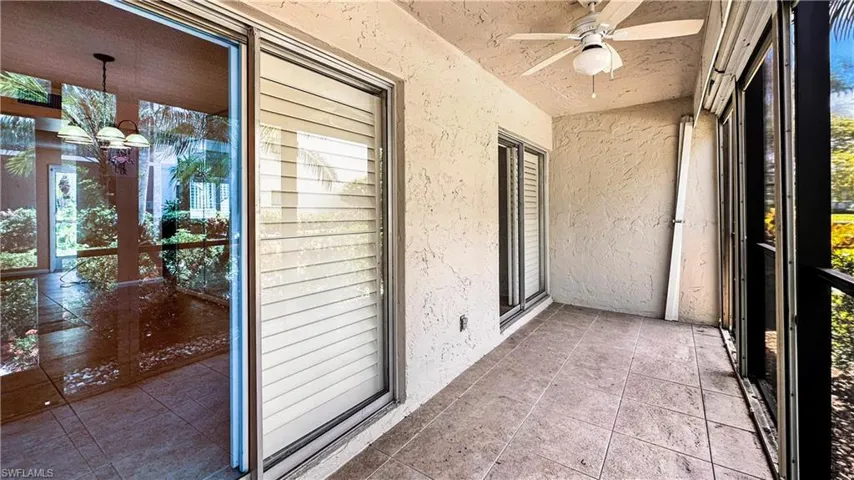 Unfurnished sunroom featuring ceiling fan
