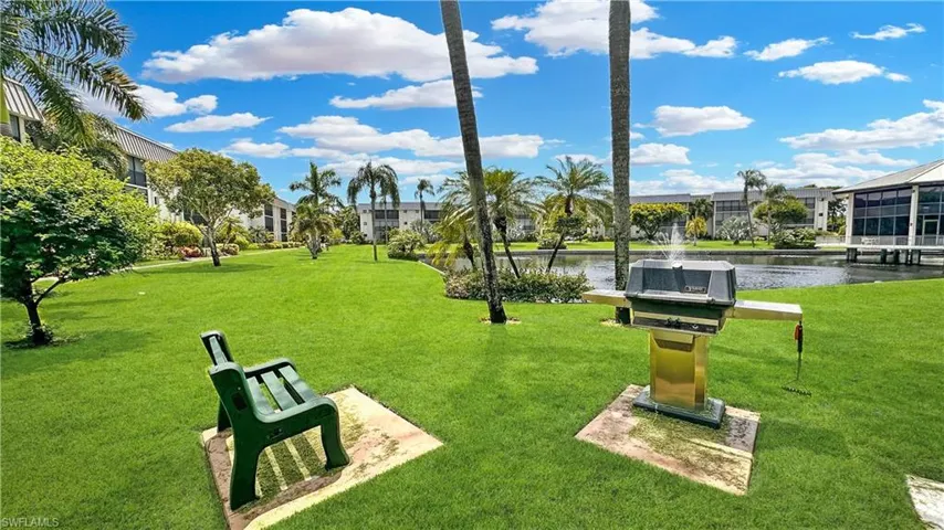 View of community with a yard and a water view