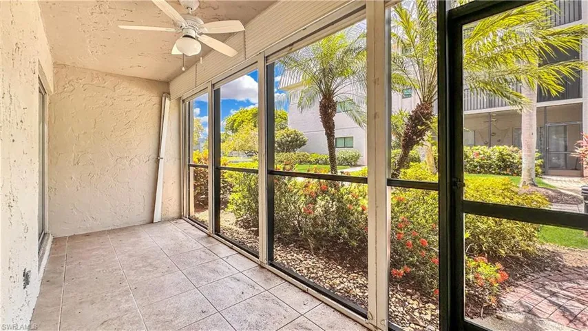 Unfurnished sunroom featuring ceiling fan