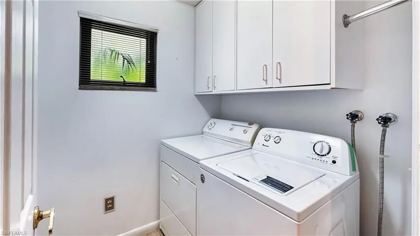 Clothes washing area with separate washer and dryer and cabinets