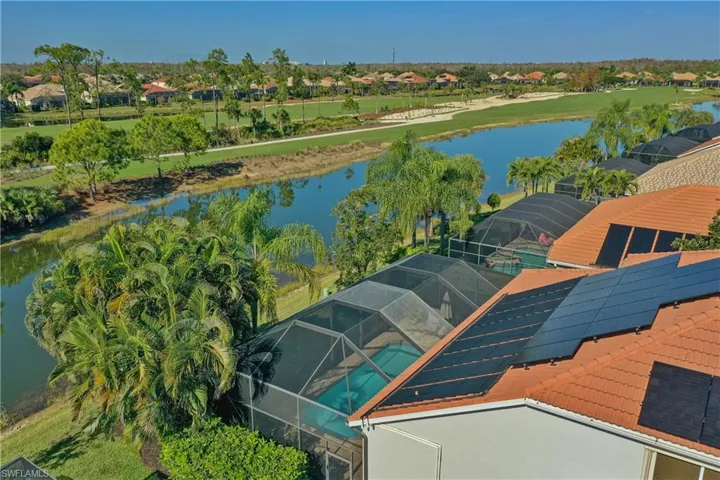 Aerial perspective of suburban area featuring a large body of water