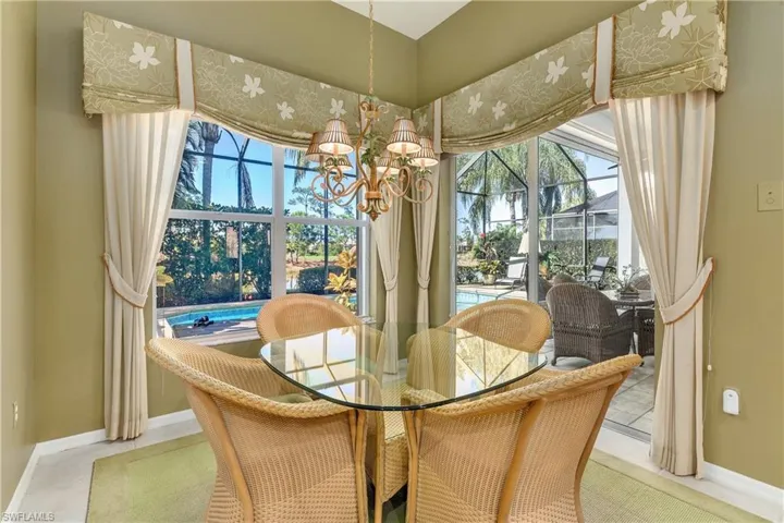 Dining space with a sunroom and a chandelier