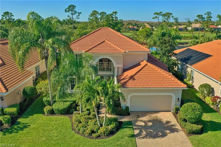 Mediterranean / spanish home with a tile roof, stucco siding, decorative driveway, and a garage