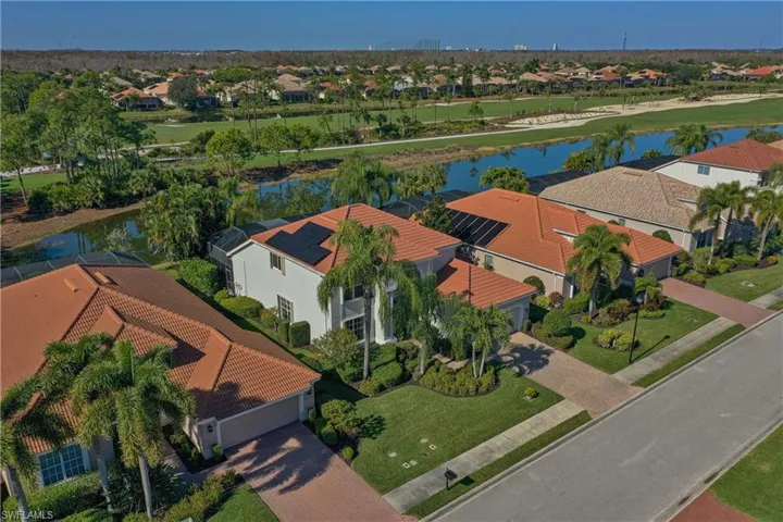 Aerial perspective of suburban area featuring a large body of water