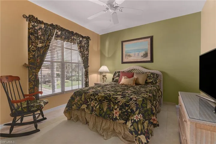 Bedroom featuring a ceiling fan and light colored carpet
