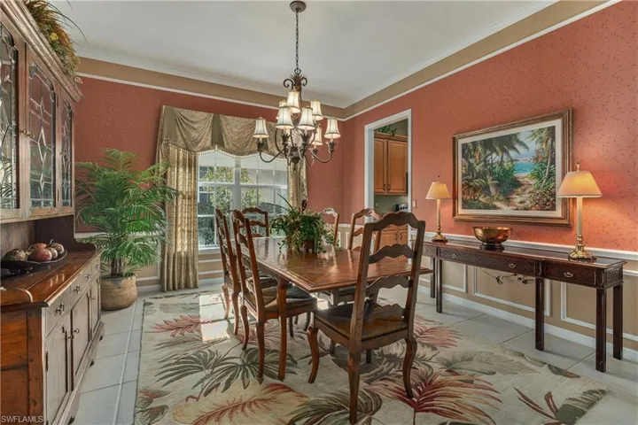 Dining room featuring a chandelier, crown molding, and light tile patterned flooring