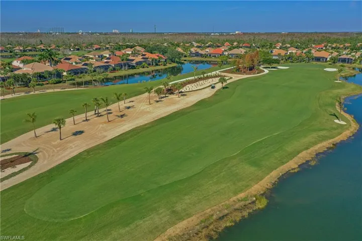 Aerial perspective of suburban area with a golf club and a nearby body of water