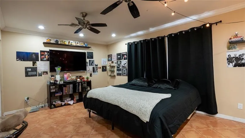 Bedroom with crown molding and recessed lighting