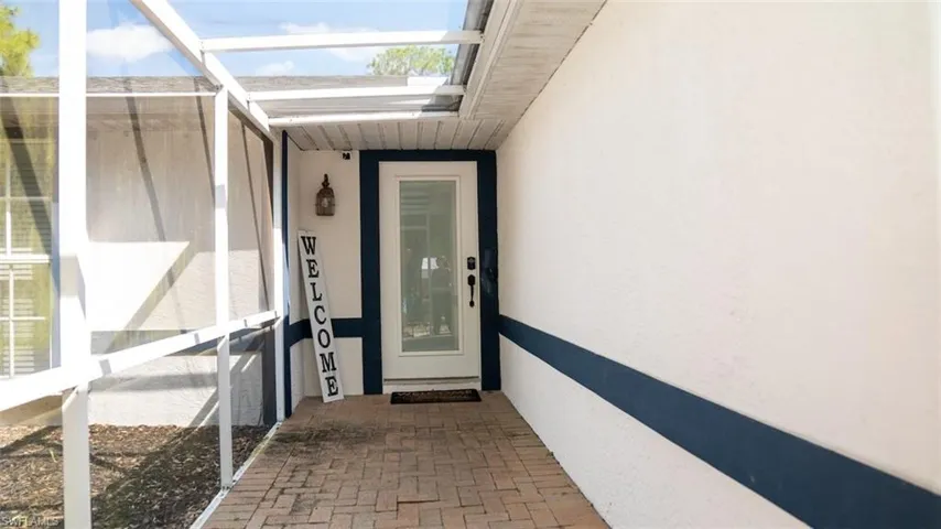 View of exterior entry featuring stucco siding