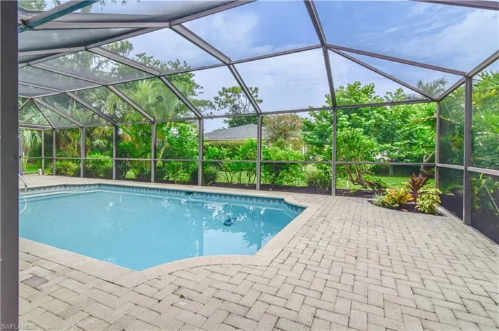 View of pool featuring a lovely planted area.