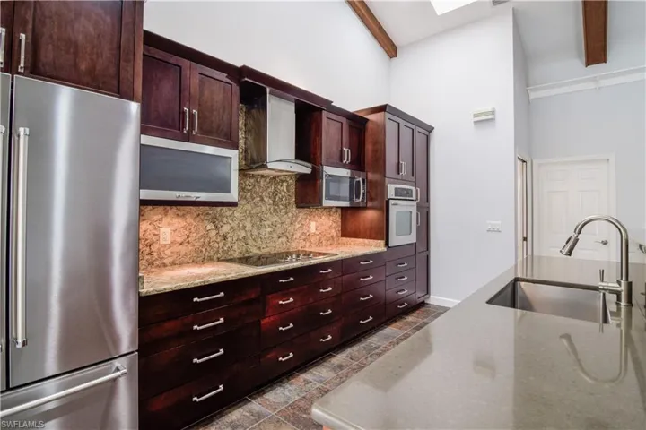 Kitchen with complimentary 2 tone solid surface counters and backsplash.