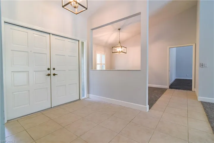 Double door front entrance and feature cut out with marble ledge.