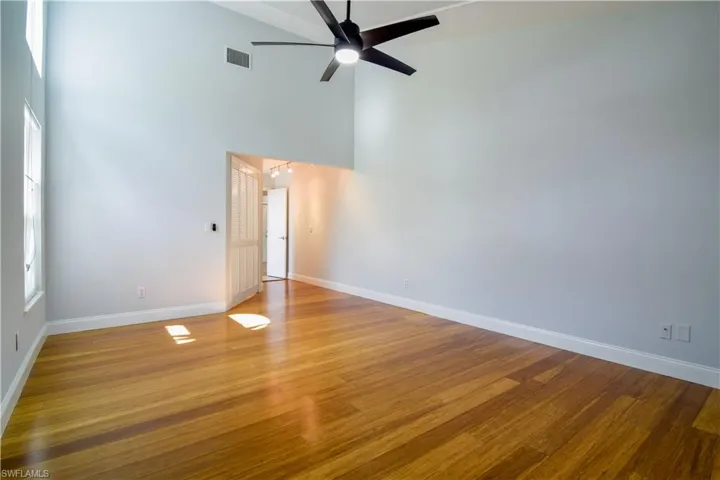 Primary bedroom with soaring vaulted ceiling.