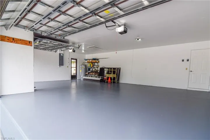 3 bay Garage with 2 new wind rated overhead doors and openers.