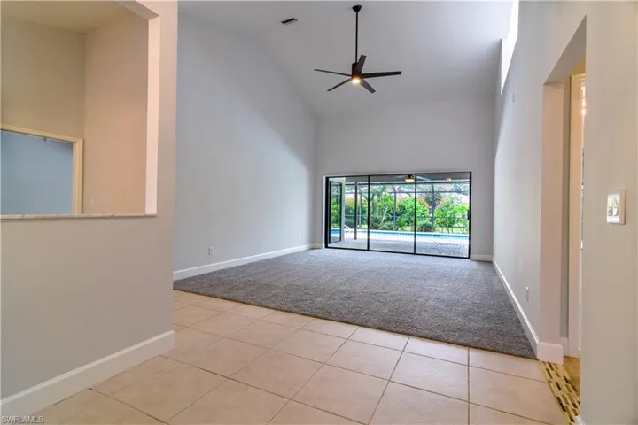 Triple slider in 2 of 3 versatile living spaces overlooking swimming pool.