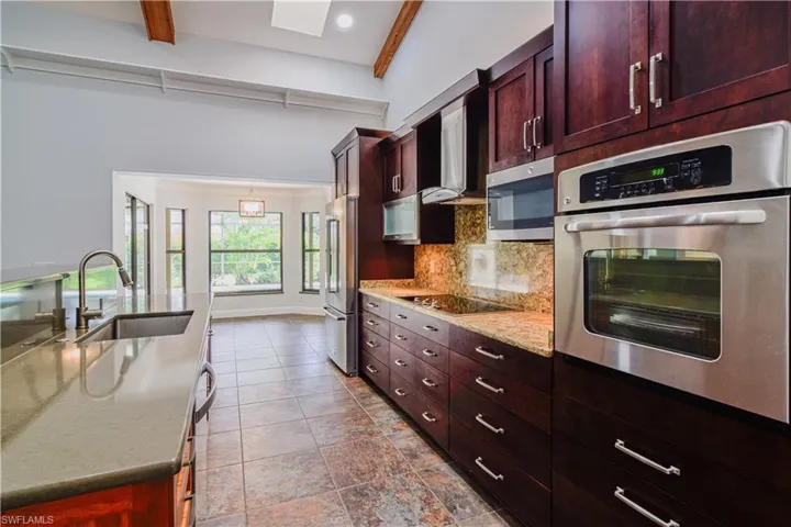 Efficient kitchen well designed with soft close drawer storage convenience, Stainless rangehood compliments appliances.