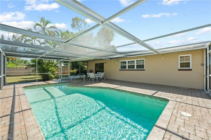 View of swimming pool featuring a lanai and a patio