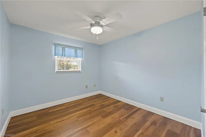 Spare room featuring hardwood / wood-style floors, ceiling fan, and a textured ceiling