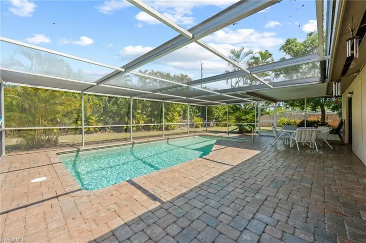 View of pool with a patio and a lanai