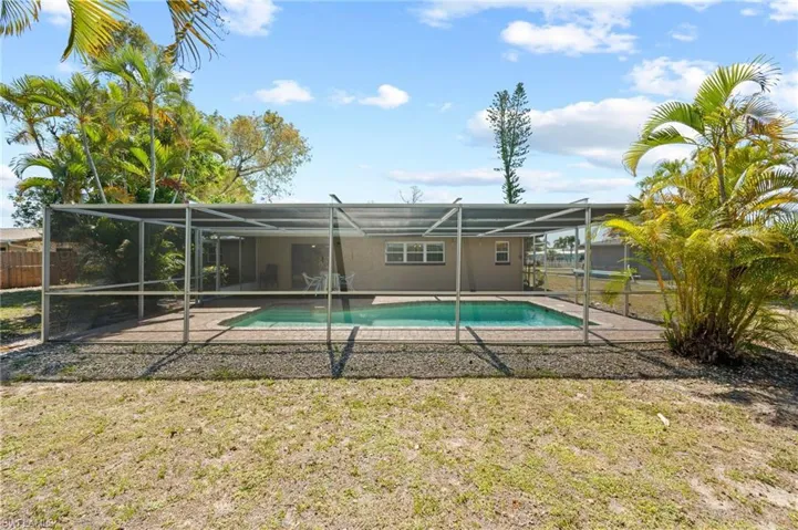 View of swimming pool with a patio area and a lanai
