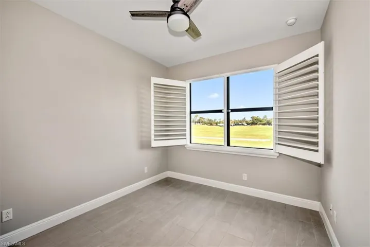 Spacious den with light wood-type flooring and ceiling fan
