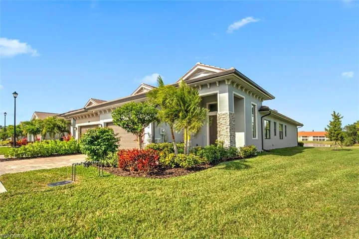 View of side of home featuring a lawn and a garage