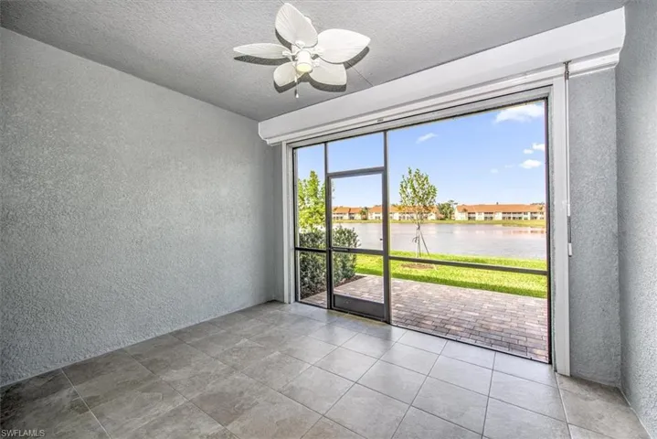 Unfurnished room with ceiling fan and a water view