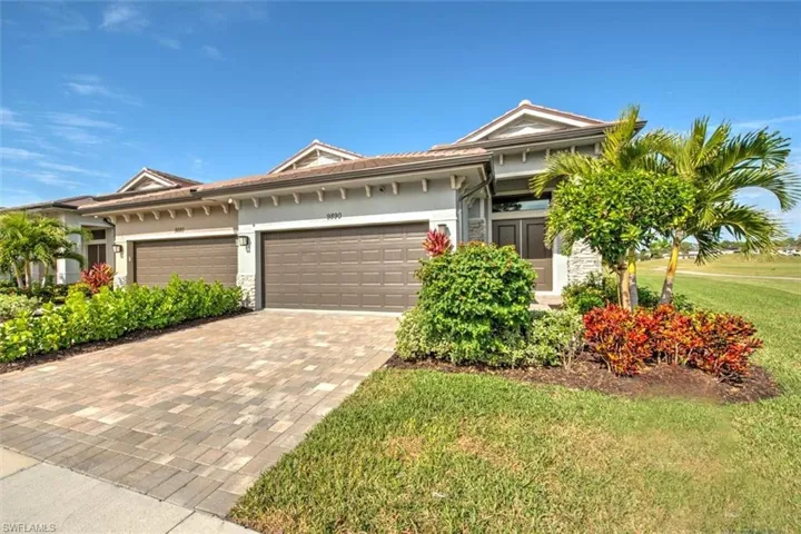 View of front of home with a front lawn and a garage