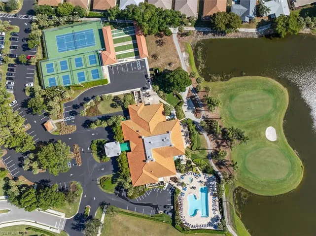 Birds eye view of property with a water view