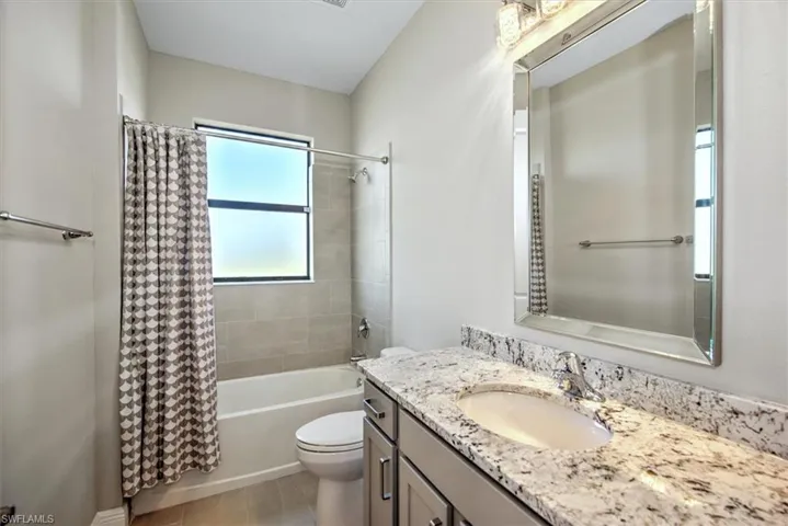 Guest Full bathroom with toilet, vanity, hardwood / wood-style flooring, and shower / bathtub combination with curtain