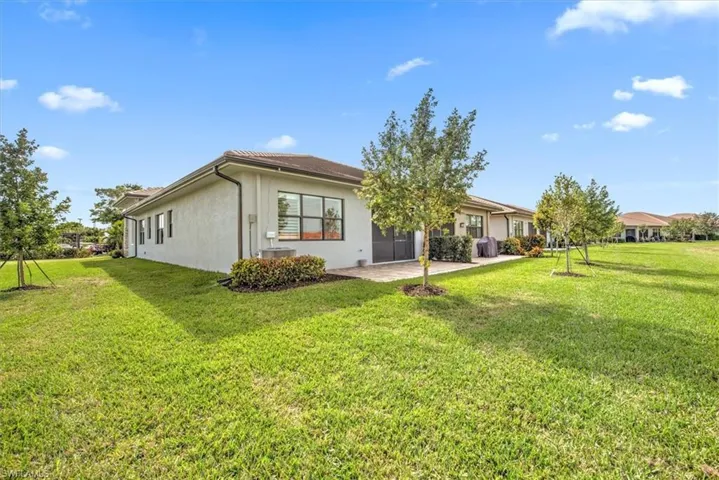 Rear view of property with a patio area and a lawn