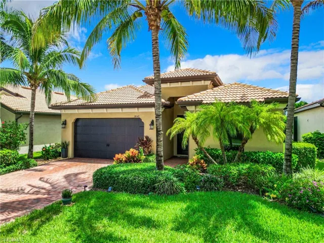 Mediterranean / spanish house with a garage and a front yard